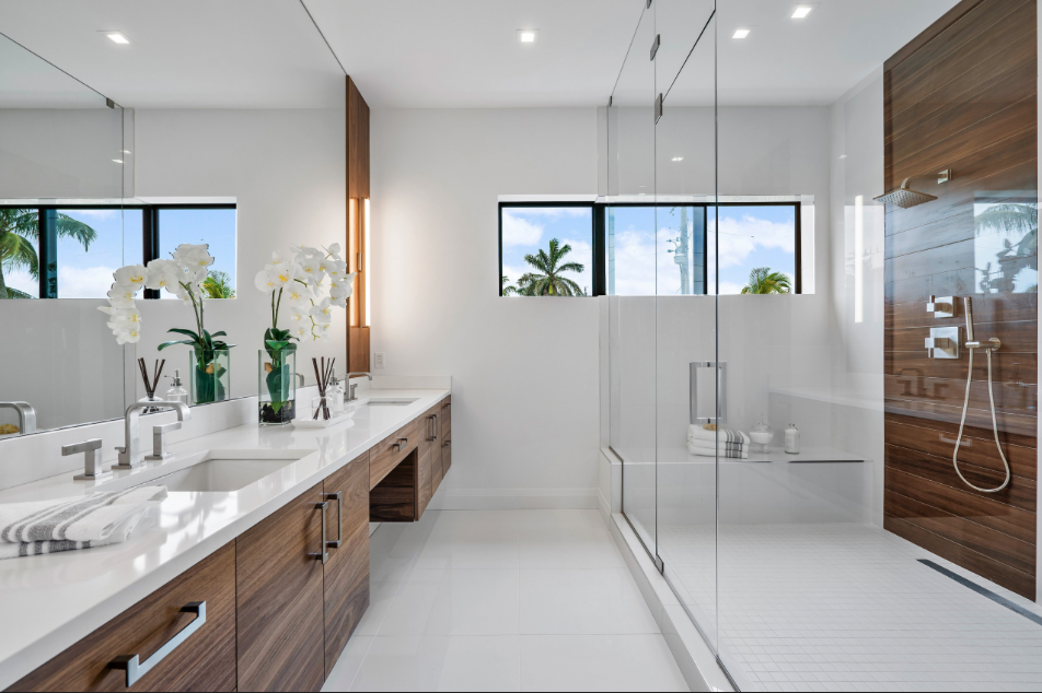 Bathroom renovation by Quintessential Renovations in Winter Garden, FL, featuring a glass-enclosed tiled shower.